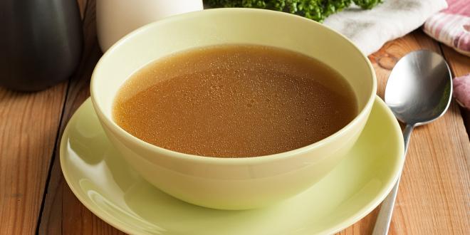 A hot bowl of bone broth prepared from beef marrow