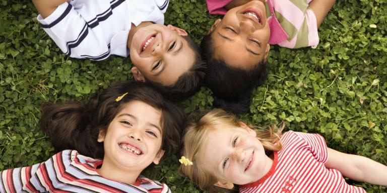 children laying in grass